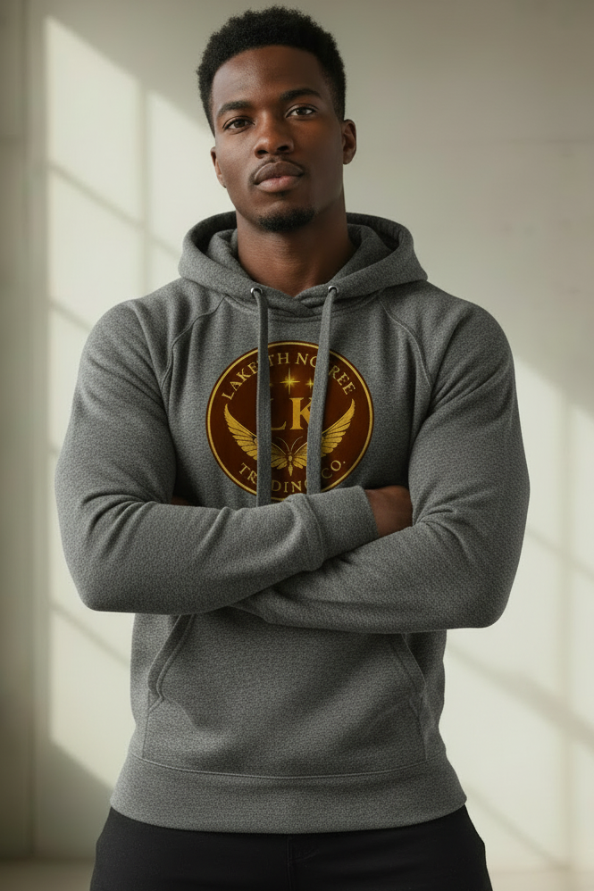 Model in confident pose wearing charcoal melange LaKeith Noirée unisex eco raglan hoodie with LKTC logo centered on chest and charcoal drawstrings